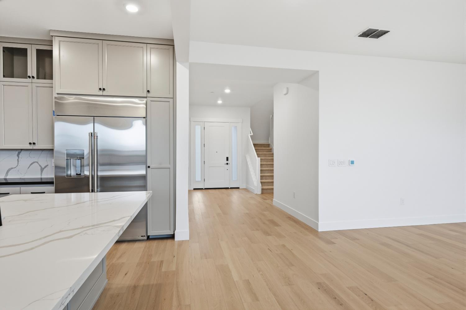 3034 Sidewinder Loop Rocklin, CA 95765 - Photo 13 of 37 a large kitchen with white cabinets and stainless steel appliances