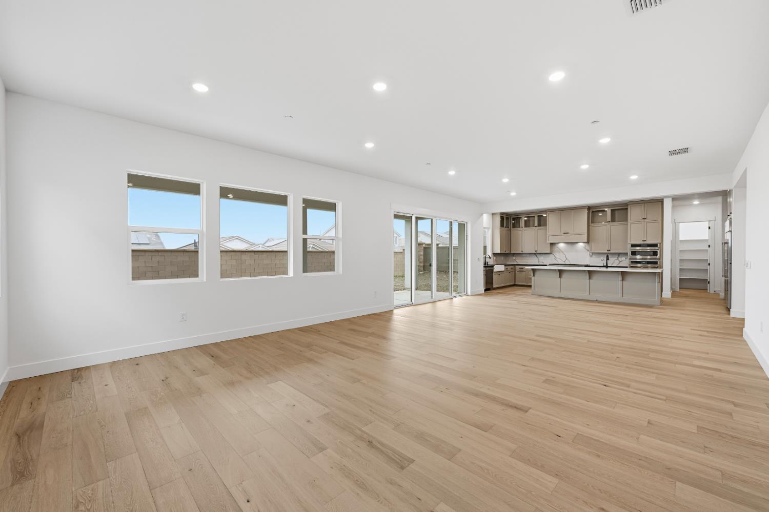 3034 Sidewinder Loop Rocklin, CA 95765 - Photo 16 of 37 a view of an empty room with wooden floor and kitchen