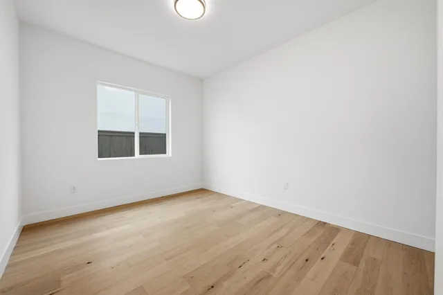 a bathroom with a granite countertop toilet and a sink