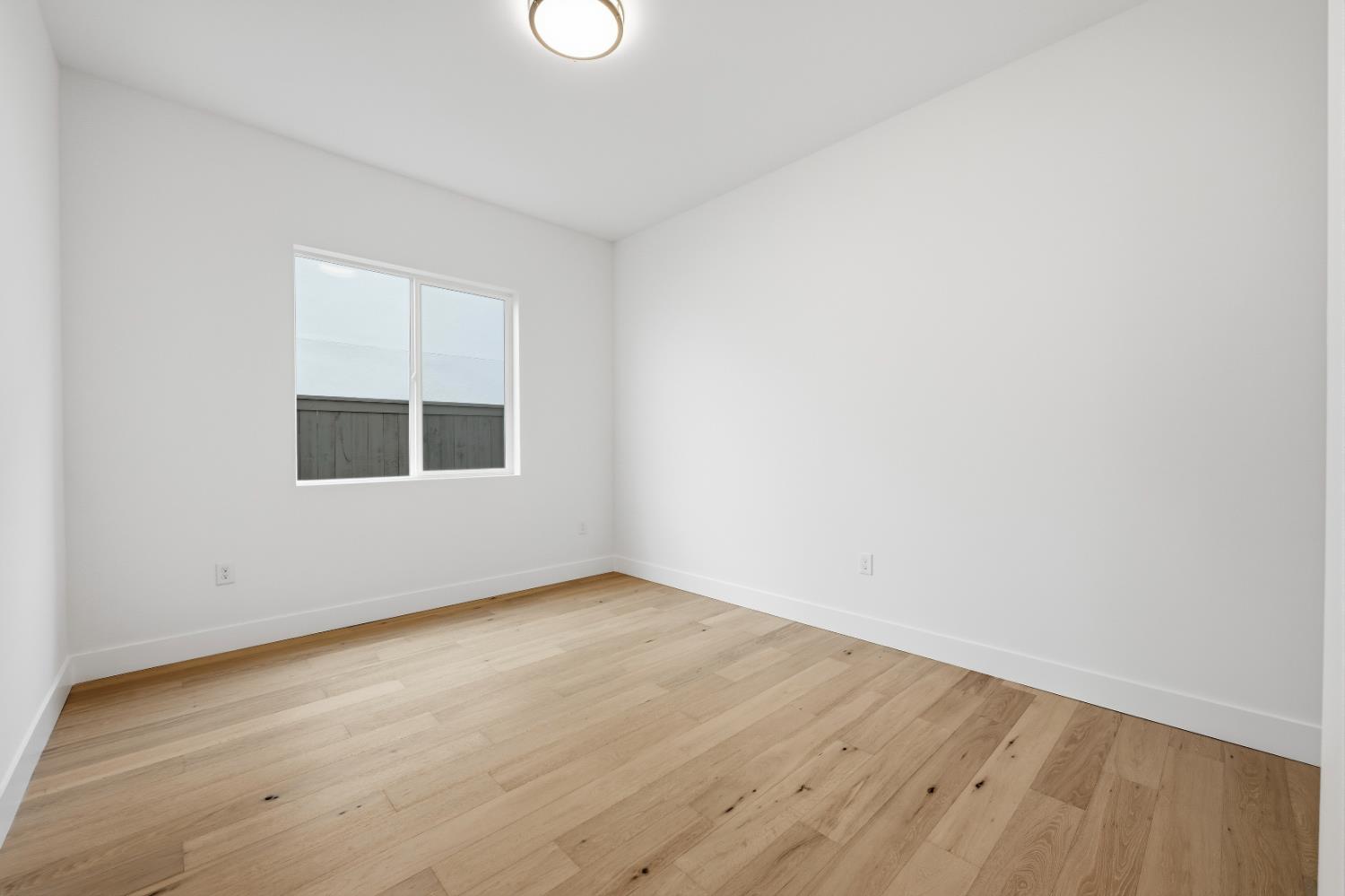 3034 Sidewinder Loop Rocklin, CA 95765 - Photo 19 of 37 an empty room with wooden floor and windows