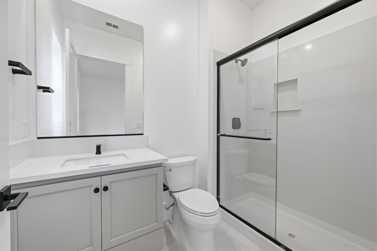 3034 Sidewinder Loop Rocklin, CA 95765 - Photo 22 of 37 a bathroom with a shower sink vanity mirror and toilet