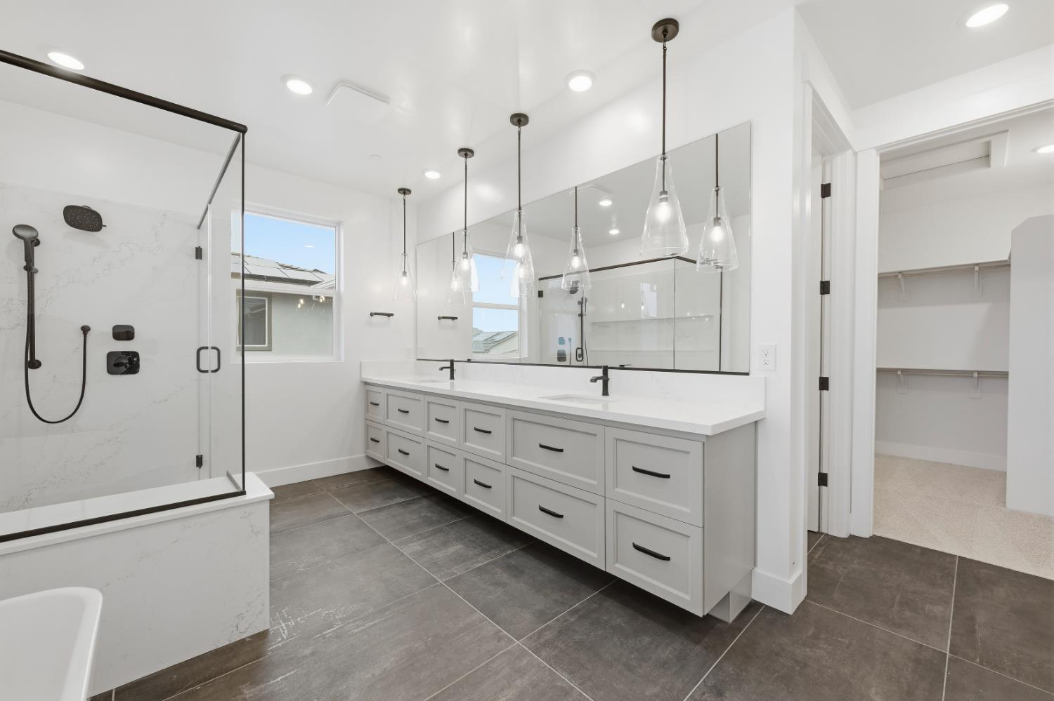 3034 Sidewinder Loop Rocklin, CA 95765 - Photo 5 of 37 a bathroom with a double vanity sink mirror double and shower