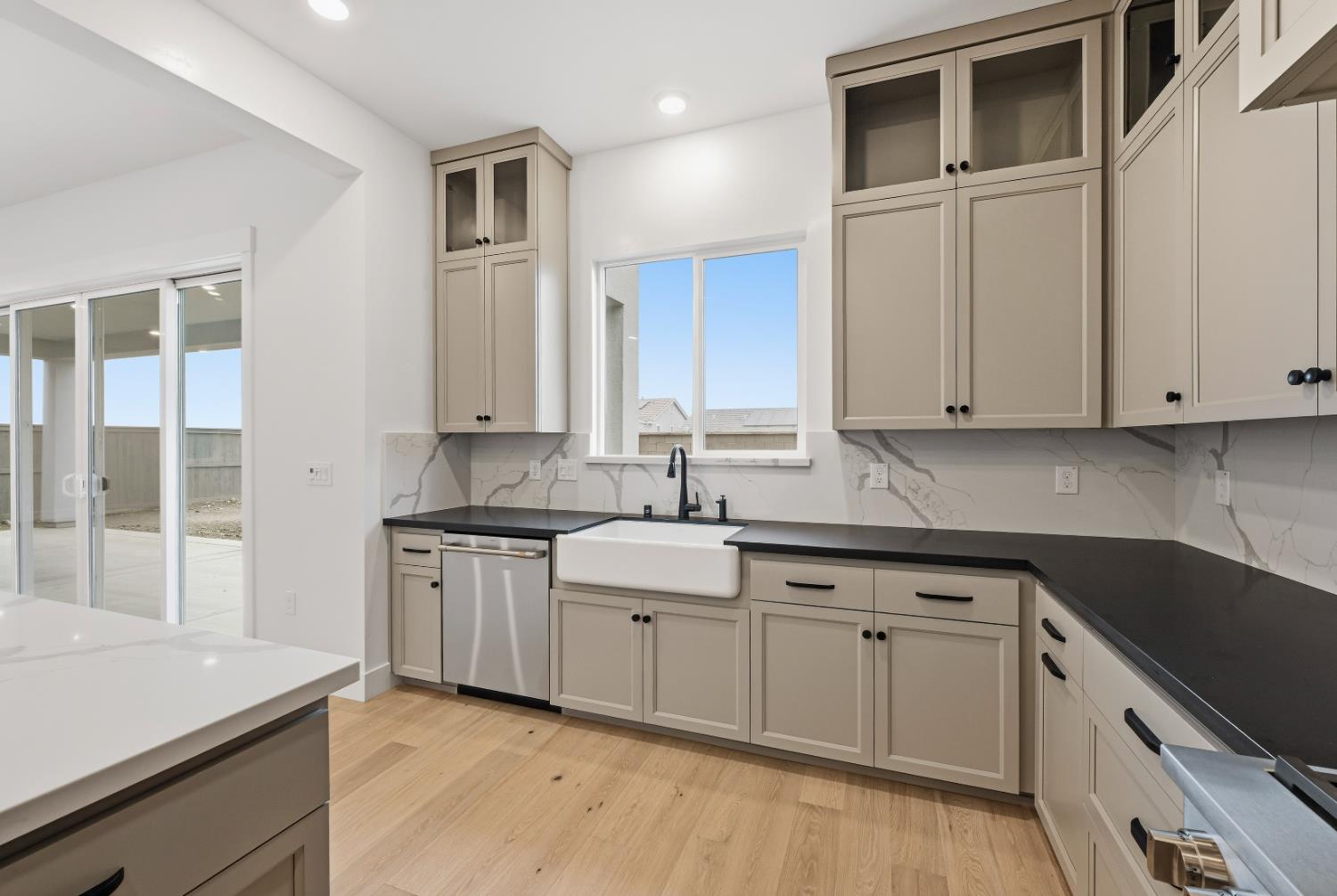 3034 Sidewinder Loop Rocklin, CA 95765 - Photo 10 of 37 a kitchen with granite countertop white cabinets and stainless steel appliances