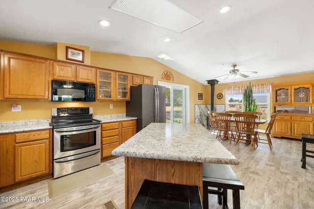 a kitchen with stainless steel appliances granite countertop a stove and more cabinets