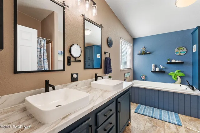 a bathroom with a double vanity sink and a mirror