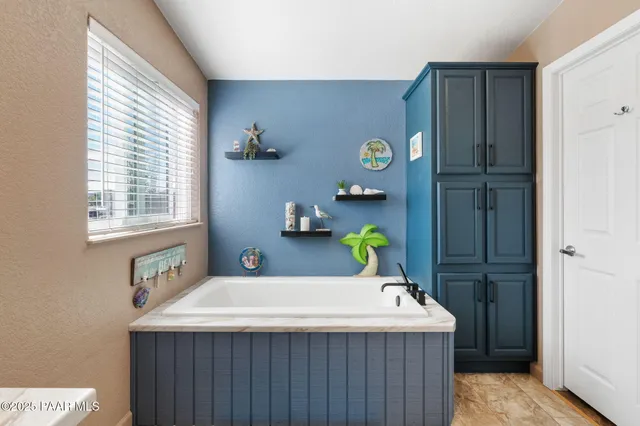 a bathroom with a sink and wooden cabinet