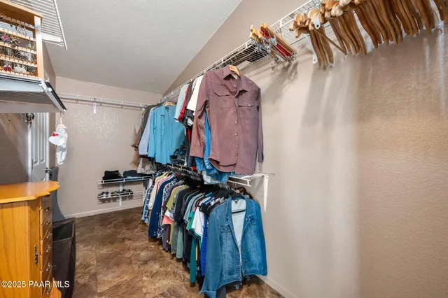 a view of walk in closet with clothes