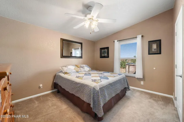 a spacious bedroom with a bed and a table