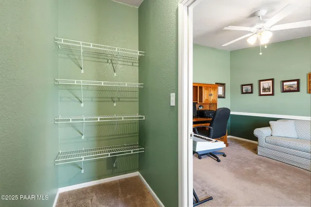 a room with a couch and a bookshelf with wooden floor