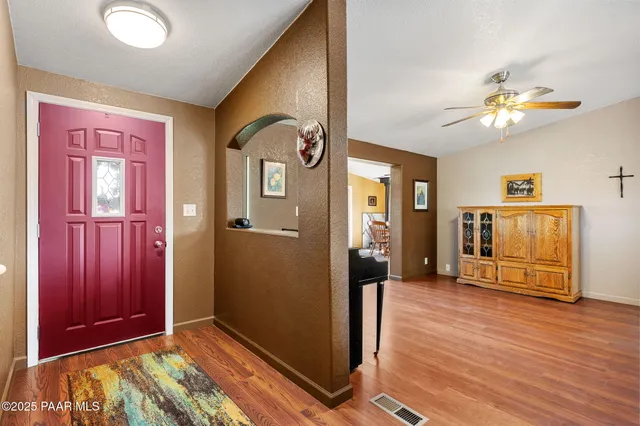a view of a livingroom with wooden floor and a flat screen tv