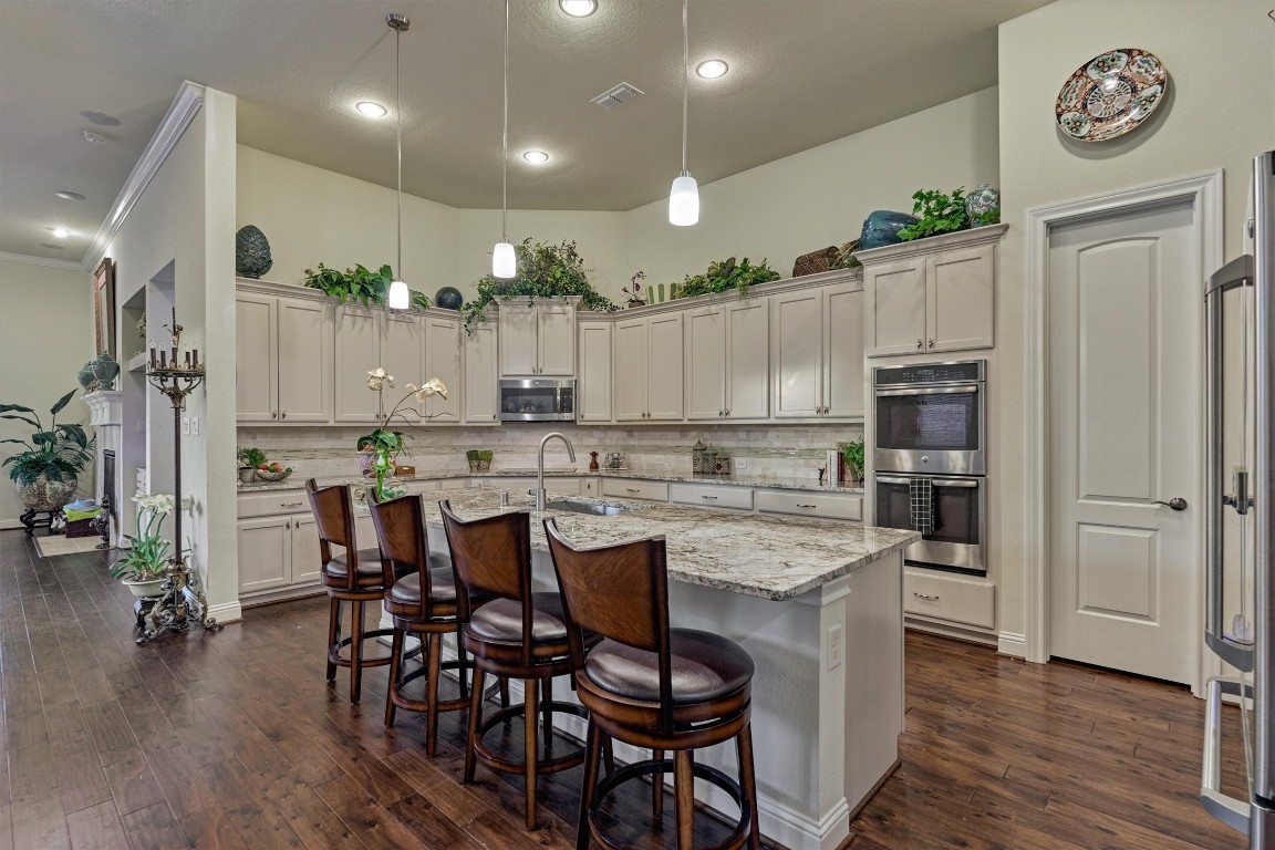 7430 Kearney Hill Lane Spring, TX 77389 - Photo 14 of 47 Beautifully designed kitchen with an oversized granite island, pendant lighting, and abundant cabinetry for storage. Open to the living area, this space is perfect for both everyday living and entertaining