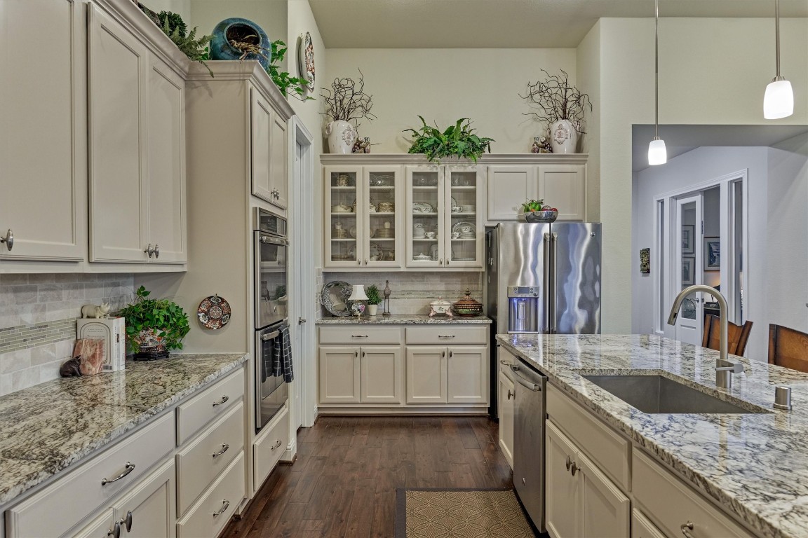 7430 Kearney Hill Lane Spring, TX 77389 - Photo 15 of 47 Well-appointed kitchen featuring granite countertops, stainless steel appliances, and ample cabinetry for storage. Light and bright with elegant finishes, this space offers both functionality and style for everyday cooking.