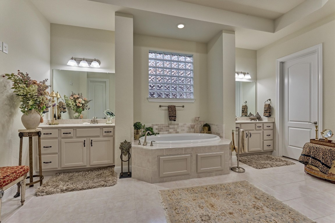 7430 Kearney Hill Lane Spring, TX 77389 - Photo 27 of 47 Spa-like primary bathroom featuring a large soaking tub, dual vanities, and elegant finishes throughout. Thoughtfully designed with abundant space and natural light, creating a relaxing and luxurious retreat.