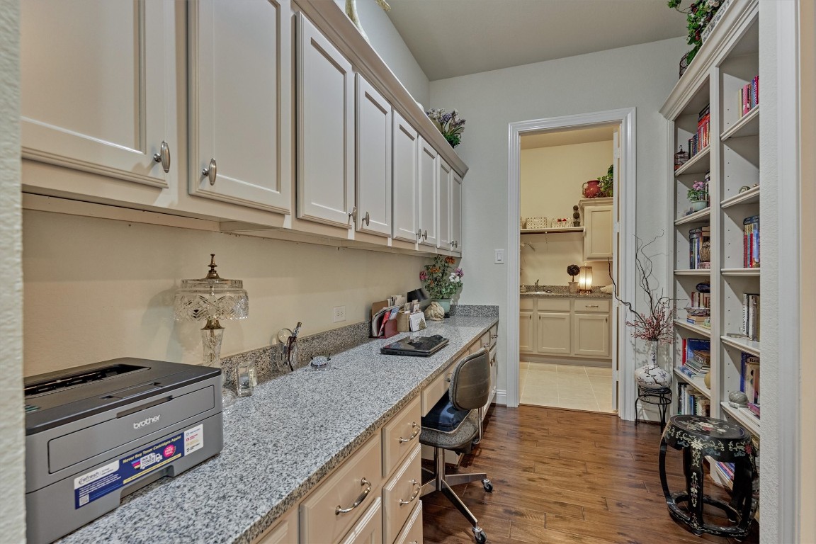 7430 Kearney Hill Lane Spring, TX 77389 - Photo 33 of 47 In addition to the study this home comes equipped this dedicated workspace with built-in cabinetry, granite countertops, and ample storage, perfect as an additional home office or study area. Conveniently located near the primary suite, offering both functionality and organization.