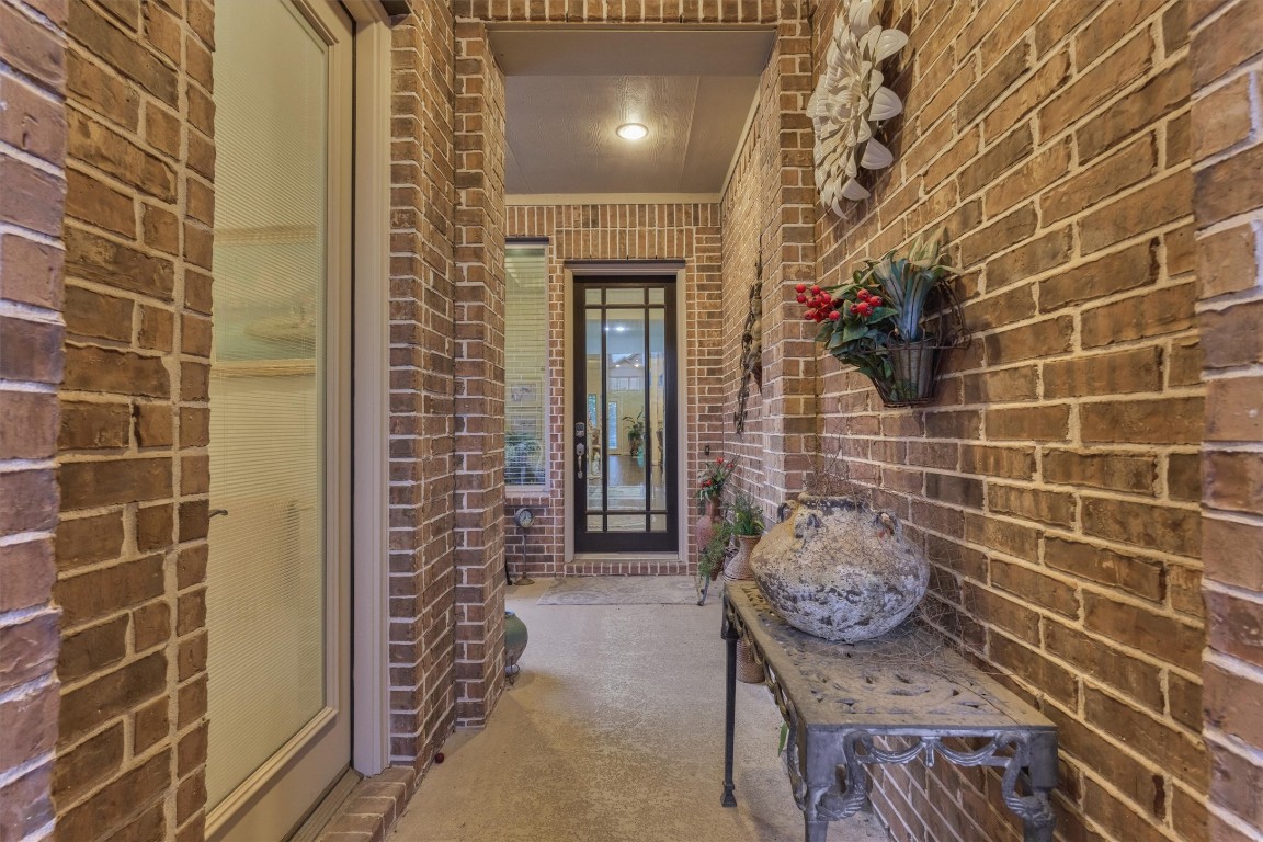 7430 Kearney Hill Lane Spring, TX 77389 - Photo 4 of 47 Private courtyard entry offering a charming and welcoming approach to the home, with the guest suite conveniently located just off to the left. This inviting space leads directly to the main house entry, creating a functional and elegant separation for guests.