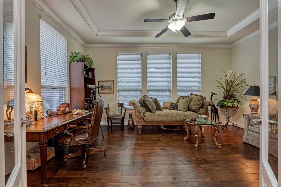 7430 Kearney Hill Lane Spring, TX 77389 - Photo 9 of 47 Elegant study featuring rich engineered wood floors, tray ceilings, and abundant natural light from multiple windows. This versatile space offers a perfect blend of comfort and functionality, ideal for a home office or quiet retreat