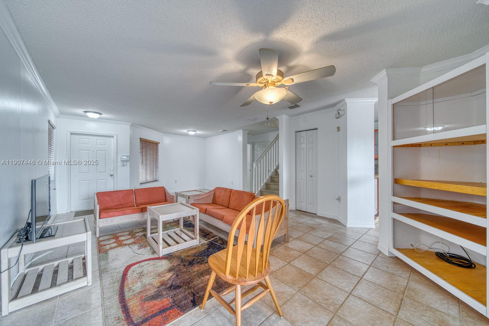 16394 Southwest 75th Street Miami, FL 33193 - Photo 11 of 35 a living room with furniture a flat screen tv and a window