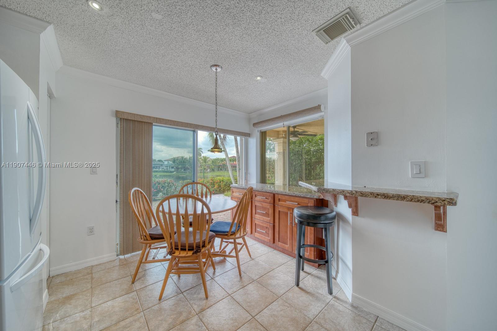 16394 Southwest 75th Street Miami, FL 33193 - Photo 16 of 35 a view of a dining room with furniture window and outside view