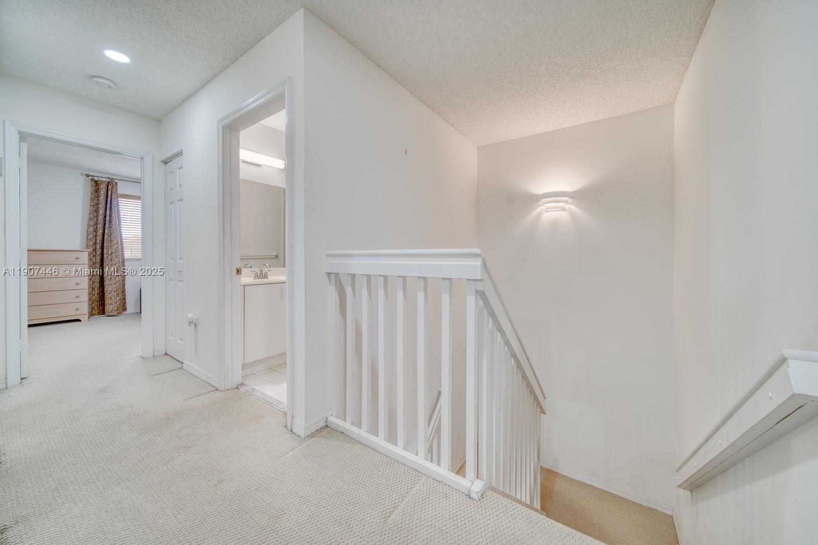 16394 Southwest 75th Street Miami, FL 33193 - Photo 17 of 35 wooden floor in a hall with a window