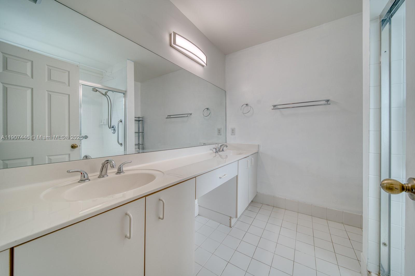 16394 Southwest 75th Street Miami, FL 33193 - Photo 20 of 35 a bathroom with a sink and a mirror
