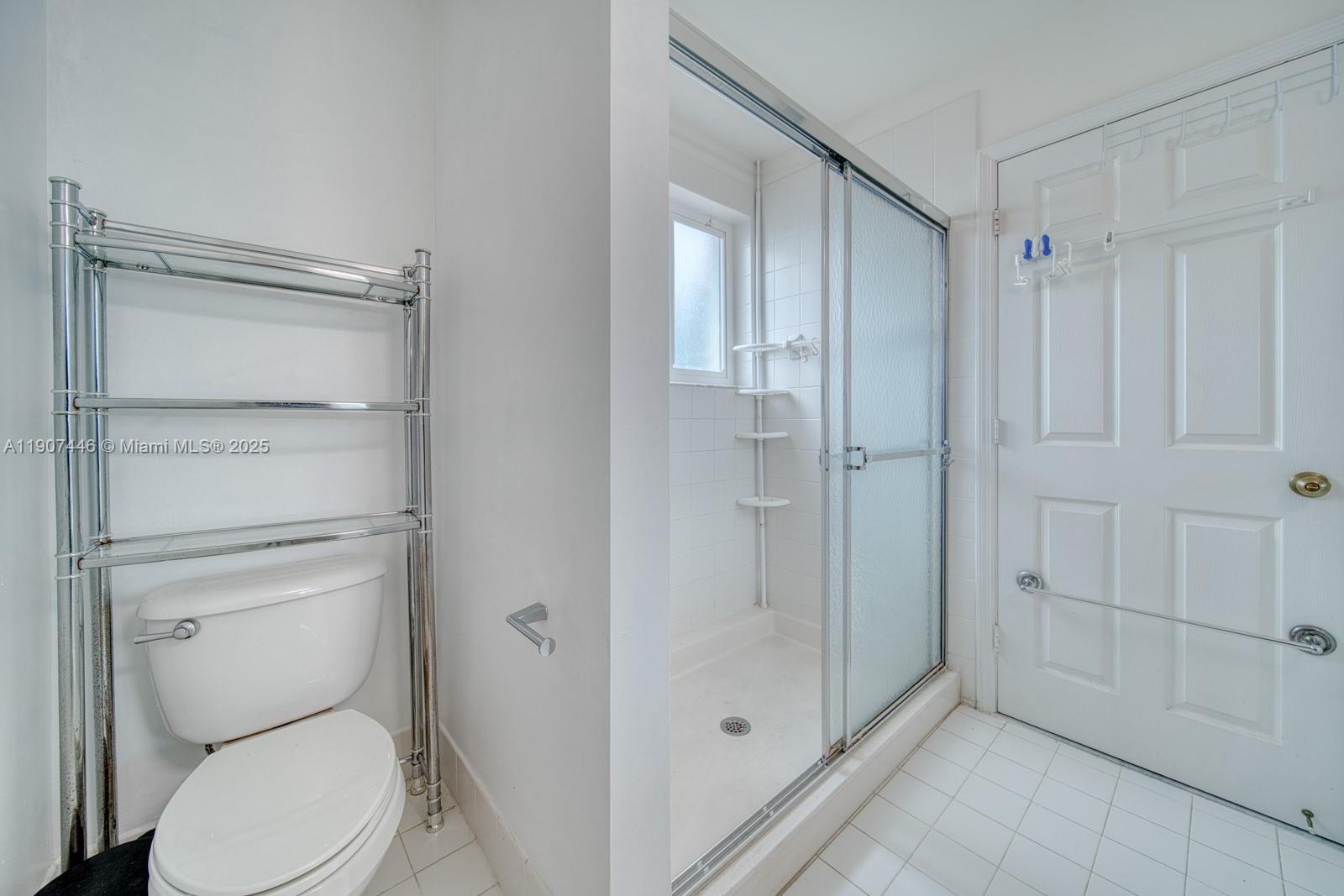 16394 Southwest 75th Street Miami, FL 33193 - Photo 21 of 35 a bathroom view of a toilet and a shower