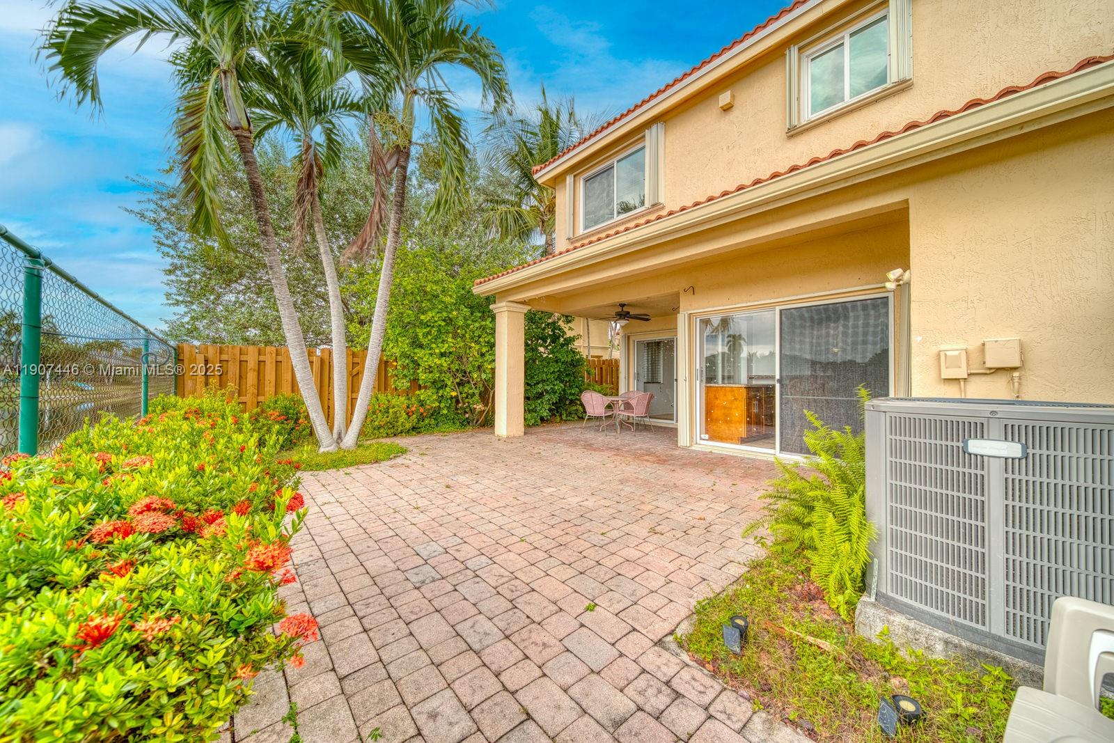 16394 Southwest 75th Street Miami, FL 33193 - Photo 31 of 35 a front view of a house with a yard