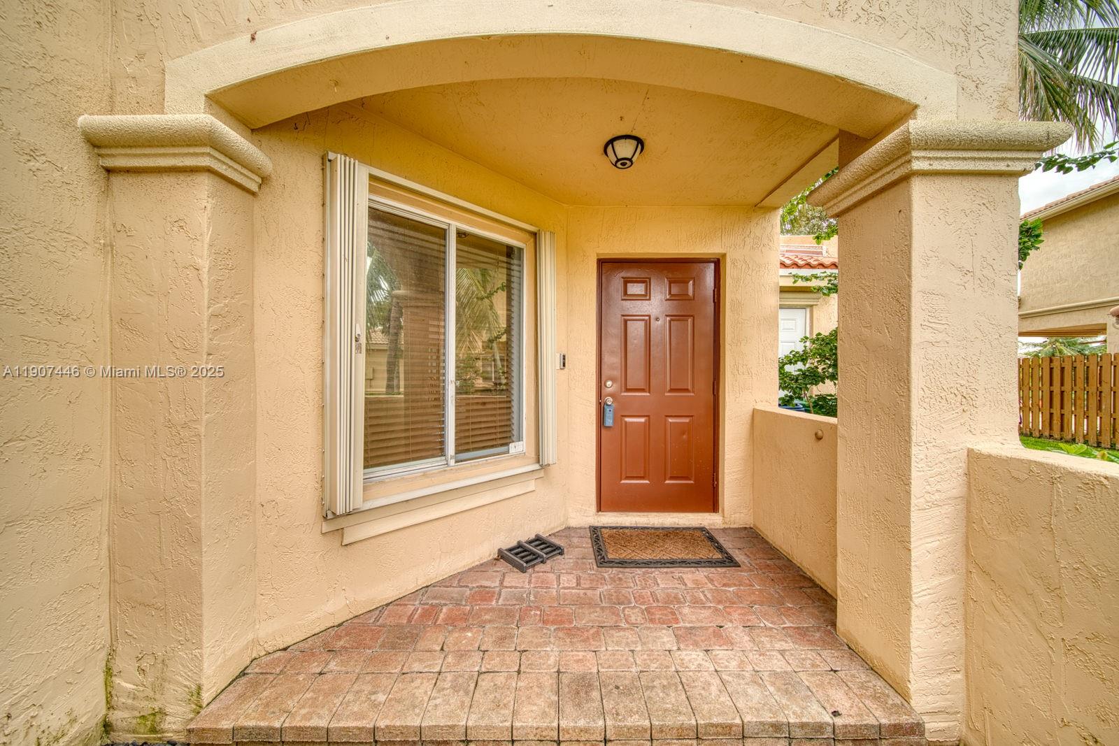 16394 Southwest 75th Street Miami, FL 33193 - Photo 7 of 35 a front view of a house with a yard