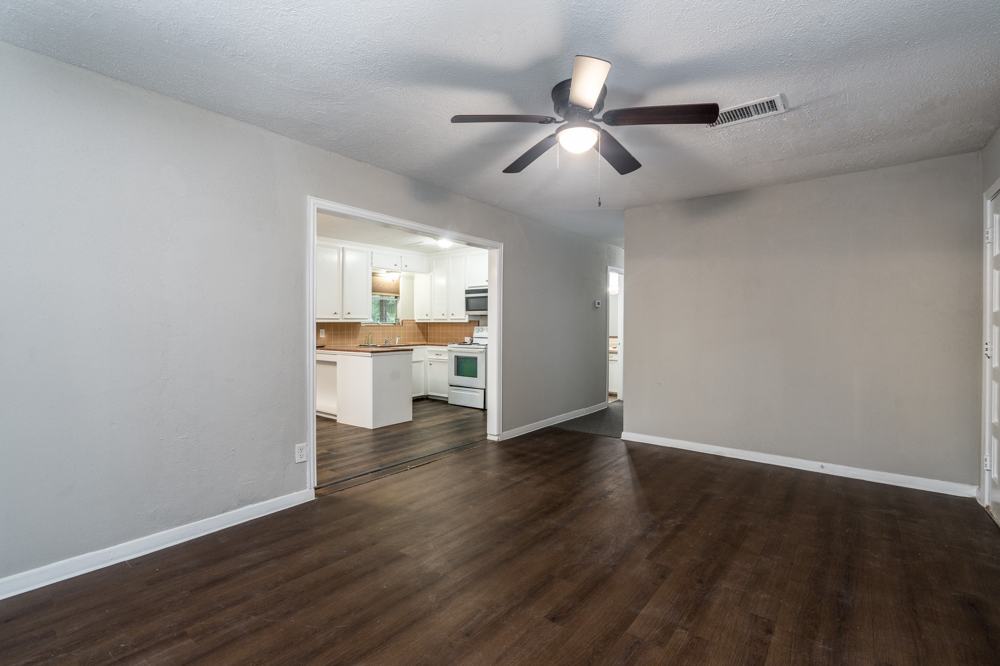 503 Carrell Street Tomball, TX 77375 - Photo 12 of 31 a view of a kitchen with wooden floor and windows