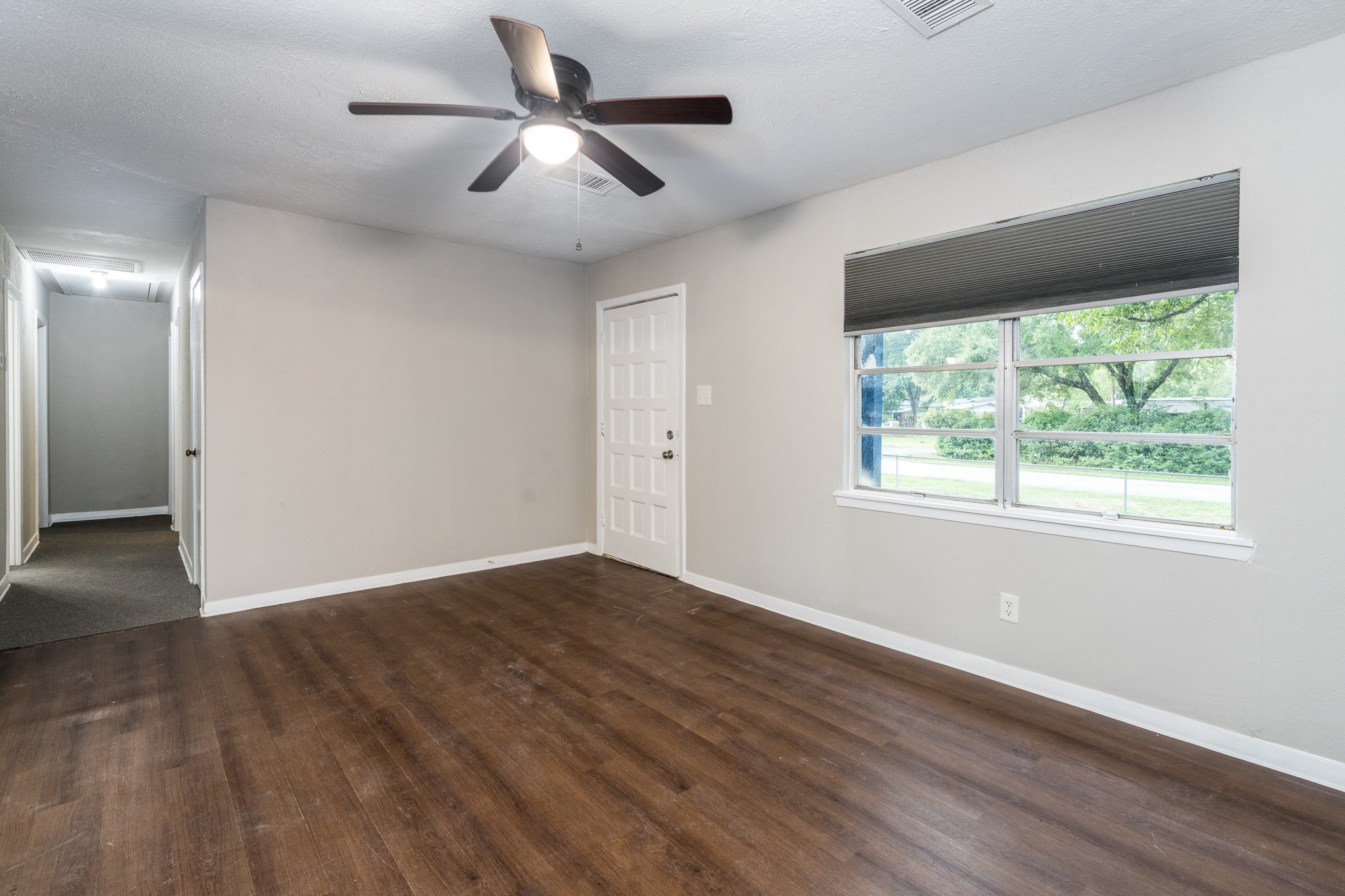 503 Carrell Street Tomball, TX 77375 - Photo 13 of 31 a view of an empty room with wooden floor and a window