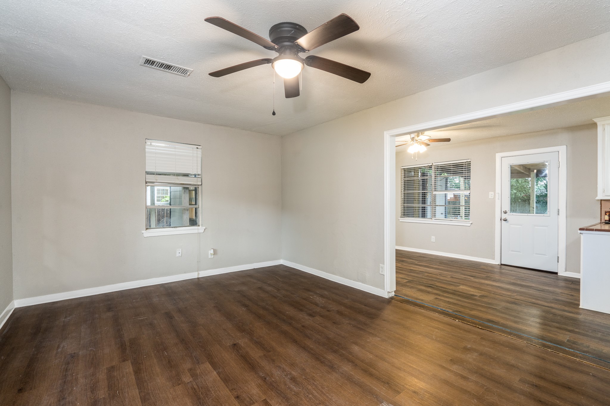503 Carrell Street Tomball, TX 77375 - Photo 15 of 31 a view of an empty room with window and wooden floor