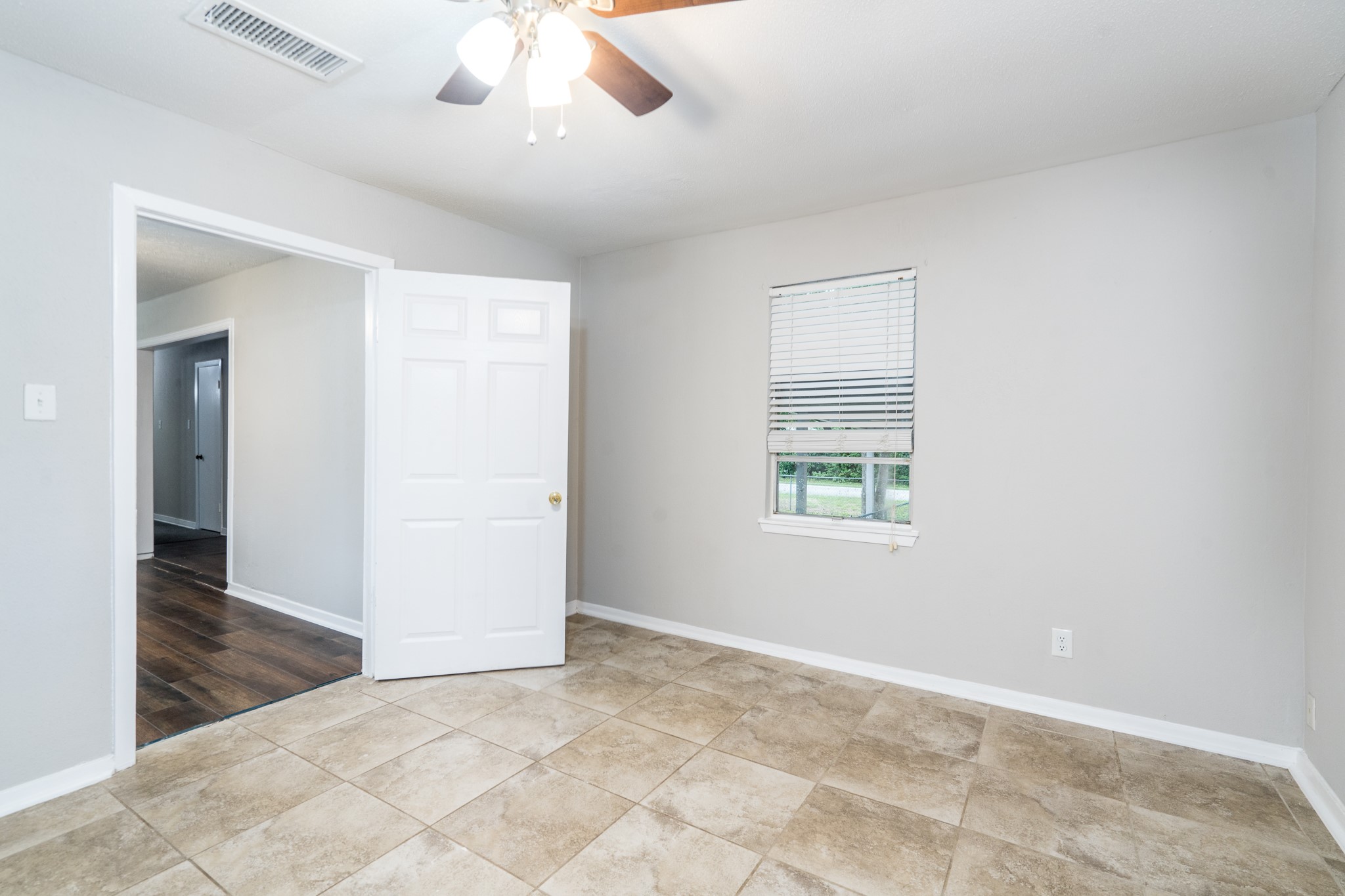 503 Carrell Street Tomball, TX 77375 - Photo 21 of 31 an empty room with chandelier fan and windows