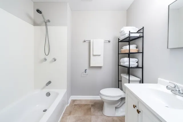 a bathroom with a toilet sink and shower