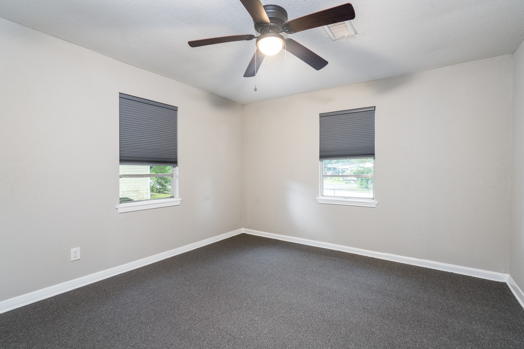 503 Carrell Street Tomball, TX 77375 - Photo 27 of 31 an empty room with a window and a fan