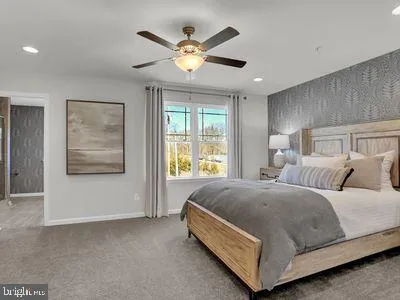 a spacious bedroom with a bed and window