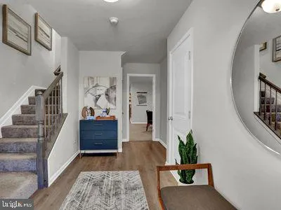 a view of entryway and hall with wooden floor