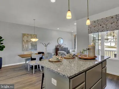 a kitchen with a counter space dining table and chairs