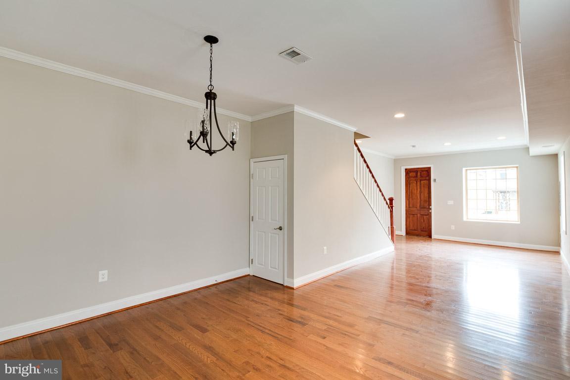 1631 U Street Southeast Washington, DC 20020 - Photo 13 of 24 a view of empty room with wooden floor and ceiling fan