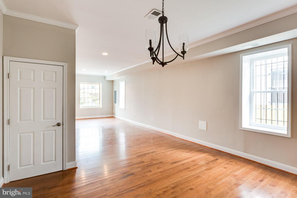 1631 U Street Southeast Washington, DC 20020 - Photo 14 of 24 a view of a room with a window and wooden floor