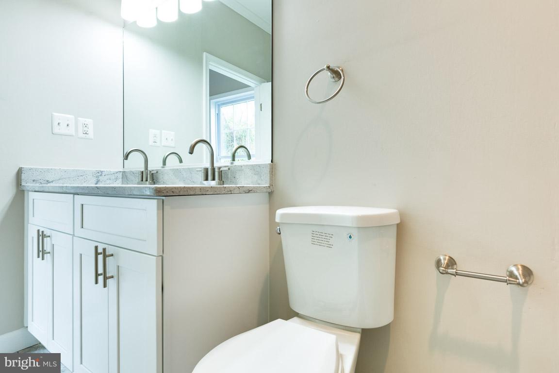 1631 U Street Southeast Washington, DC 20020 - Photo 15 of 24 a bathroom with a toilet sink and mirror