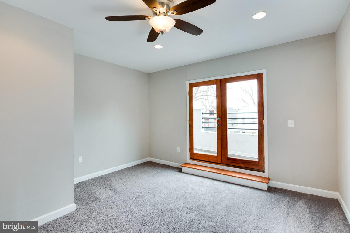 1631 U Street Southeast Washington, DC 20020 - Photo 20 of 24 an empty room with windows and fan