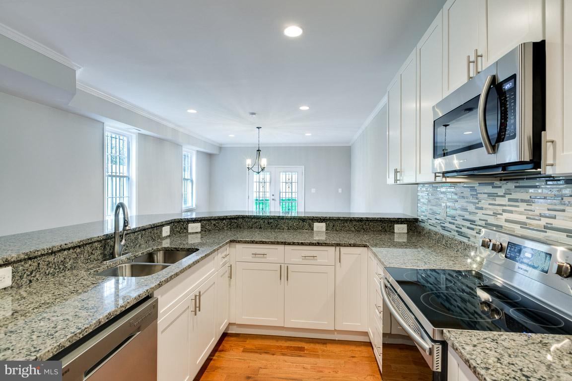 1631 U Street Southeast Washington, DC 20020 - Photo 3 of 24 a kitchen with a sink stove top oven and microwave