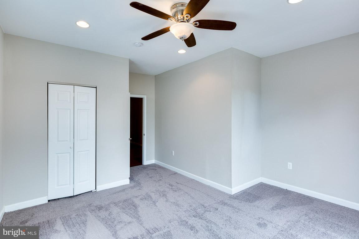 1631 U Street Southeast Washington, DC 20020 - Photo 24 of 24 an empty room with closet and a ceiling fan