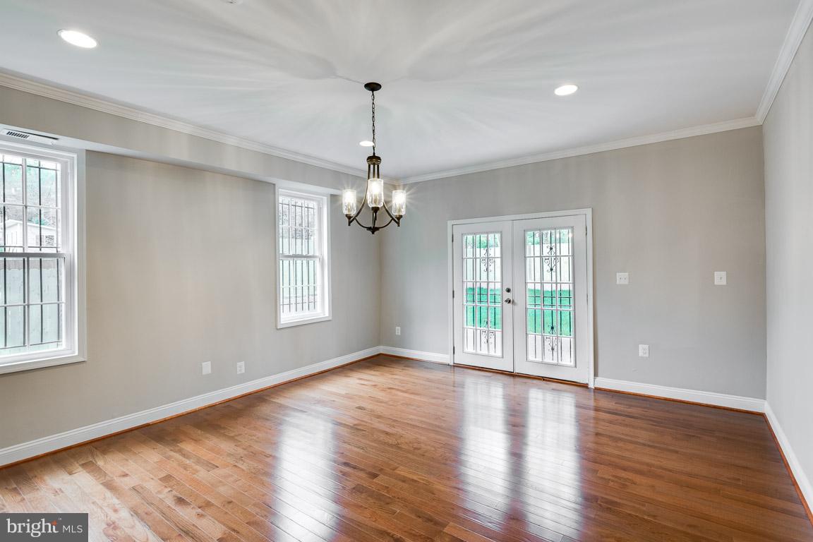 1631 U Street Southeast Washington, DC 20020 - Photo 5 of 24 a view of an empty room with wooden floor and a window