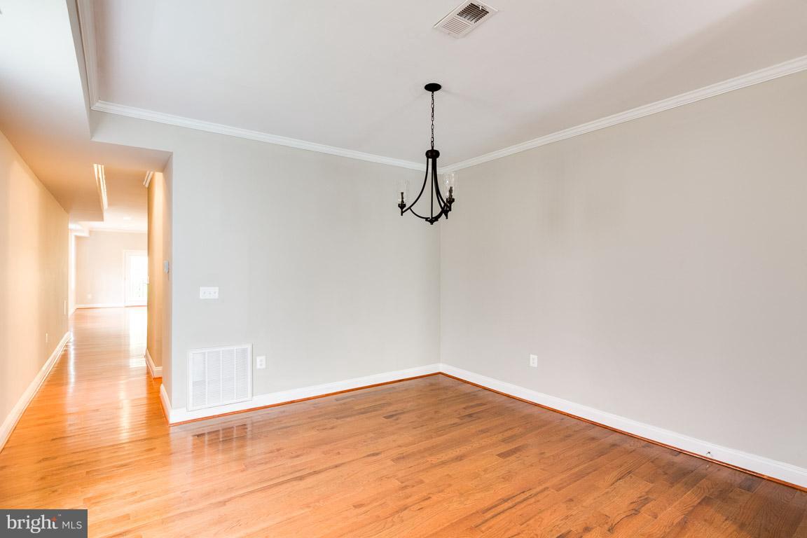 1631 U Street Southeast Washington, DC 20020 - Photo 10 of 24 a view of a room with wooden floor and white walls