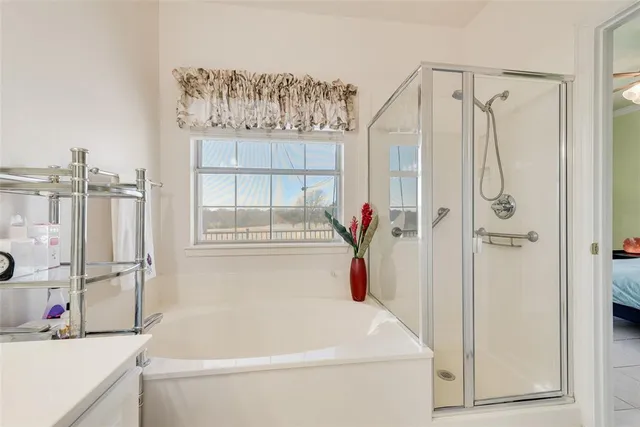 a bathroom with a tub and a shower