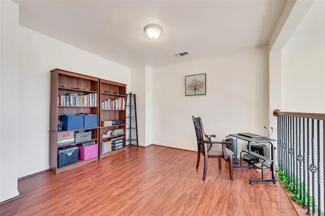 a view of a workspace with furniture and wooden floor