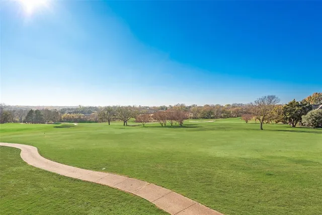 a view of a grassy field with an ocean