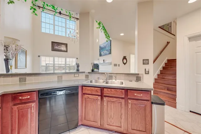 a kitchen with granite countertop a sink and cabinets