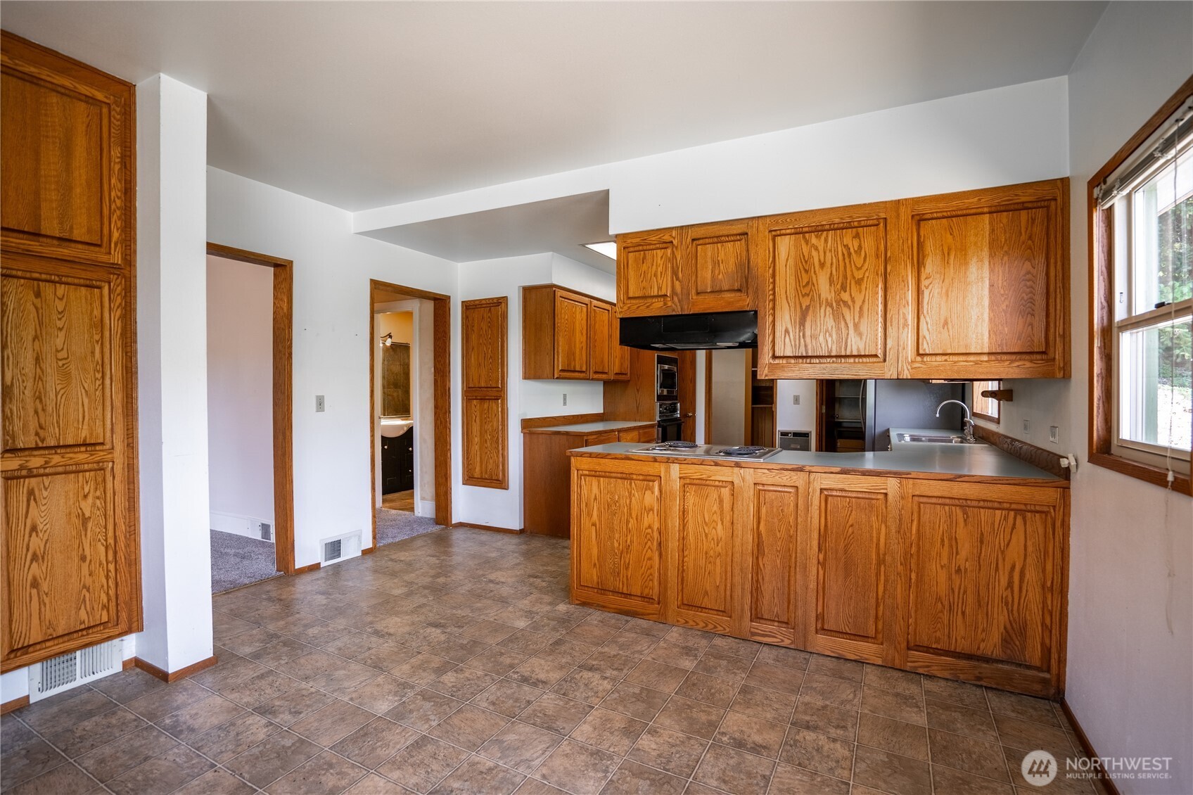 15 Beebe Fish Hatchery Road Chelan, WA 98816 - Photo 11 of 40 a kitchen with stainless steel appliances a sink and large window