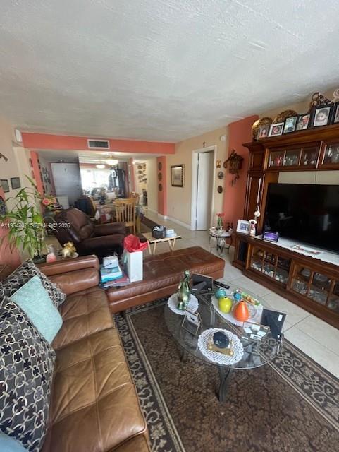 14250 Southwest 62nd Street, Unit 320 Miami, FL 33183 - Photo 4 of 14 a living room with furniture and a flat screen tv